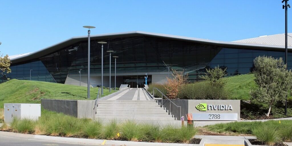 Exterior of Nvidia's headquarters building in Santa Clara, California, with an angular glass roof.